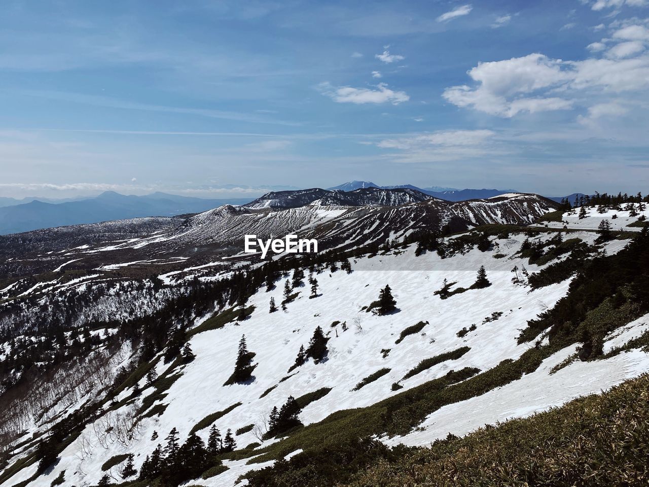 mountain, snow, environment, landscape, scenics - nature, sky, cold temperature, winter, beauty in nature, mountain range, ridge, cloud, nature, wilderness, non-urban scene, no people, tranquility, snowcapped mountain, tranquil scene, travel, summit, travel destinations, land, day, plateau, outdoors, tourism, rock, idyllic, extreme terrain, mountain pass, remote