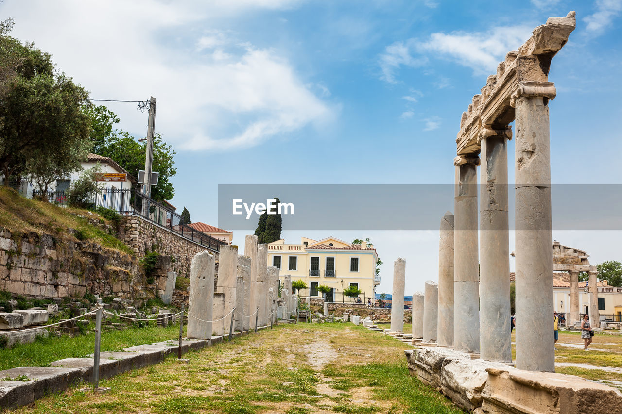 Tourists visiting the ancient ruins at the roman agora in athens