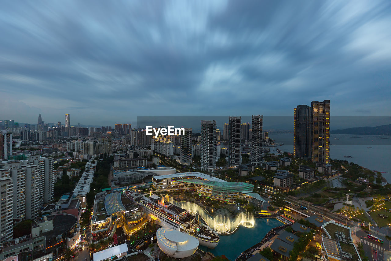 HIGH ANGLE VIEW OF MODERN BUILDINGS AGAINST SKY