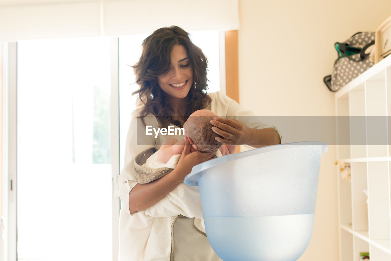 YOUNG WOMAN SMILING AT HOME