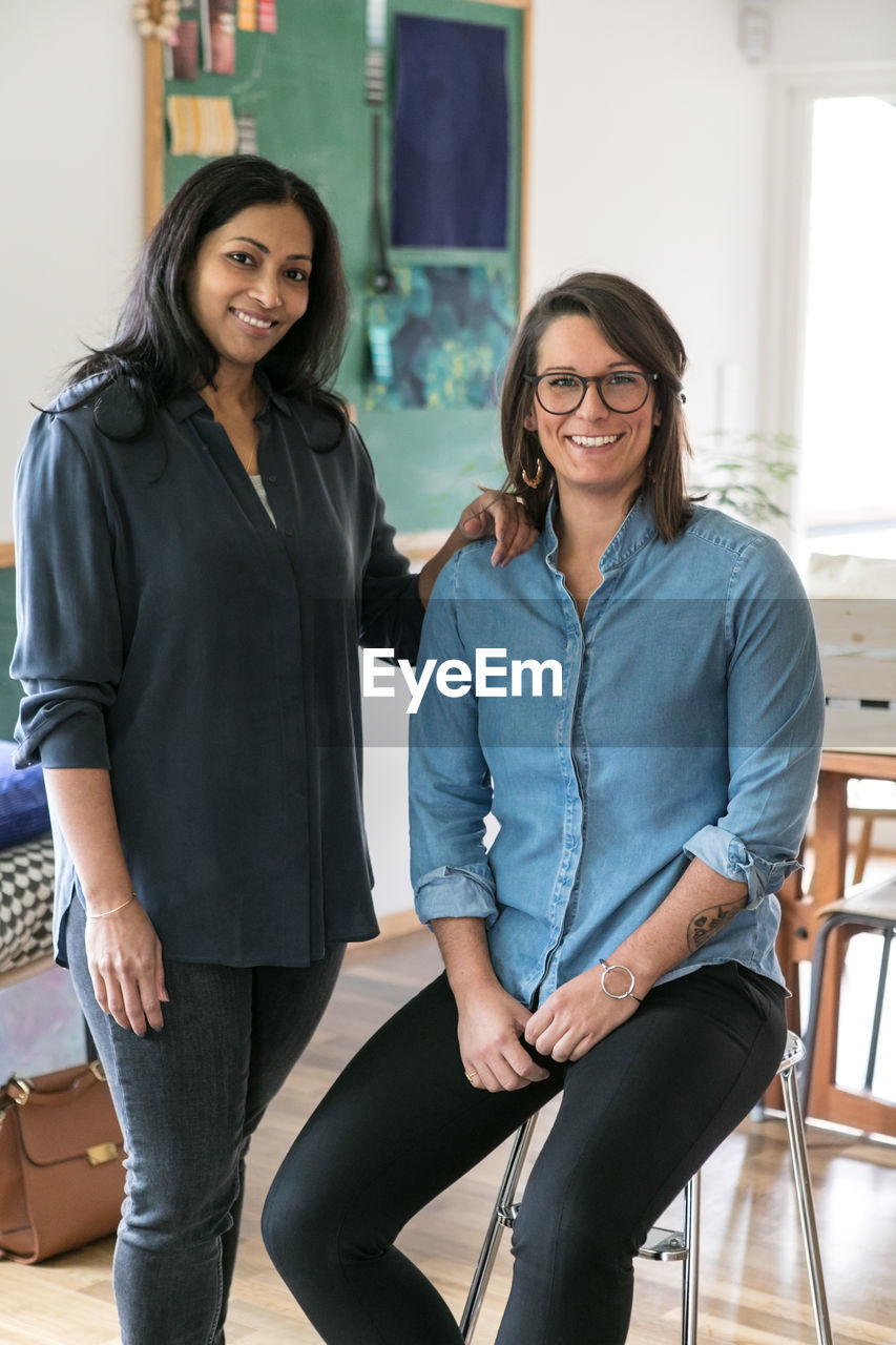 Portrait of smiling female design professionals in home office