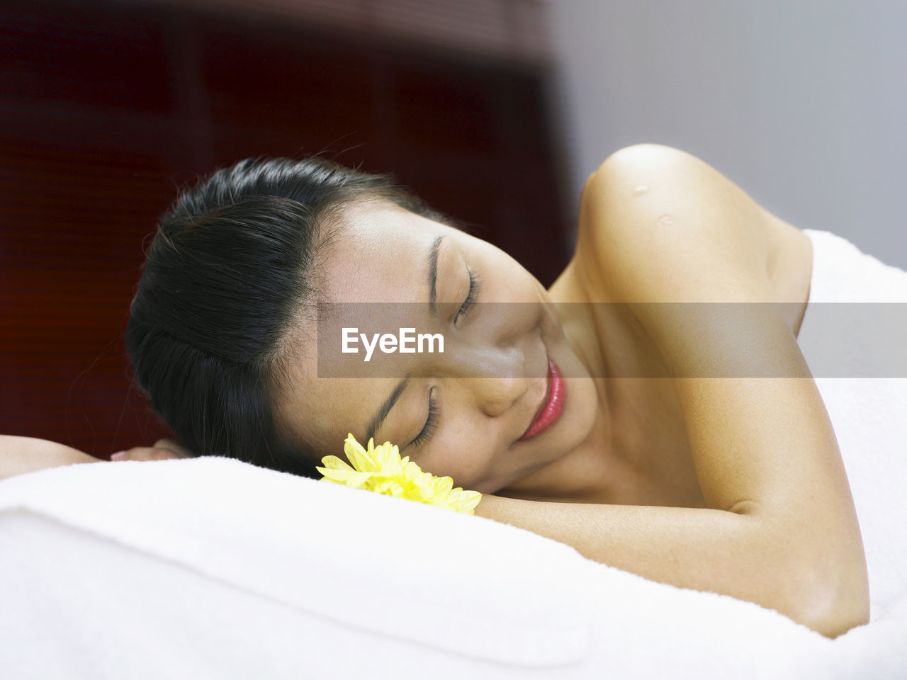 Woman having spa treatment while lying on massage table