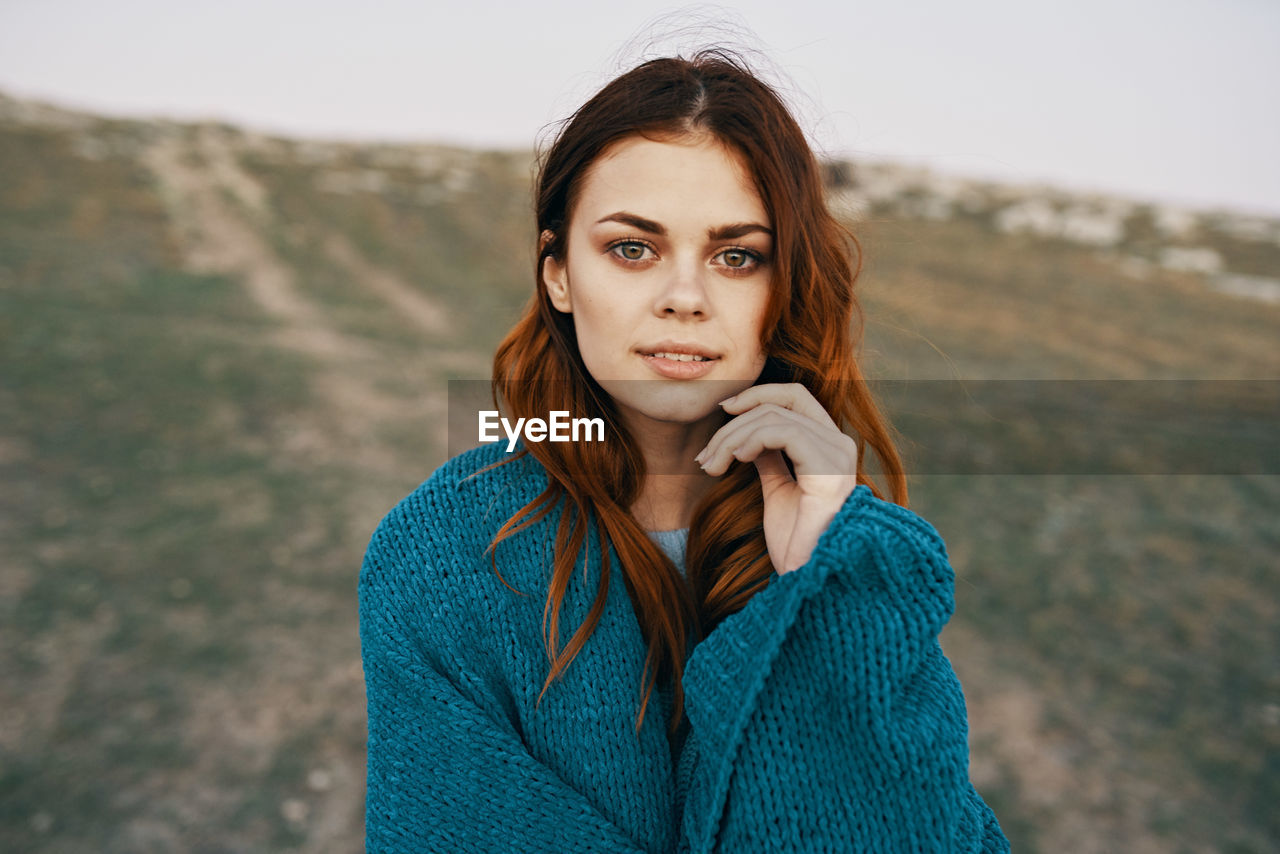 PORTRAIT OF A BEAUTIFUL YOUNG WOMAN WITH RED EYES