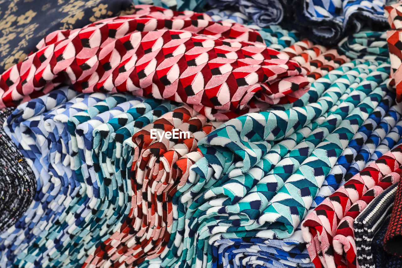 Samples of cloth and fabrics in different colors found at a fabrics market.