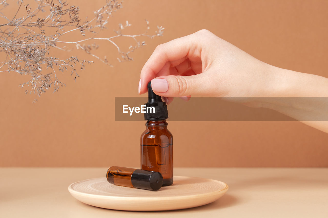 Cropped hand of person holding gavel on table