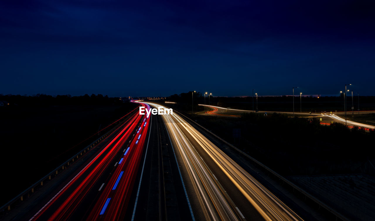 High angle view of light trails on highway at night