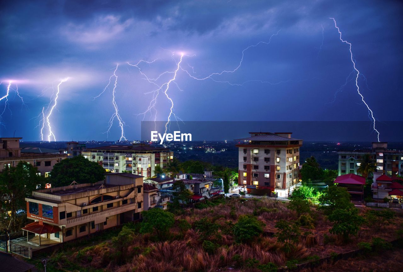 Lightning over buildings in city at night