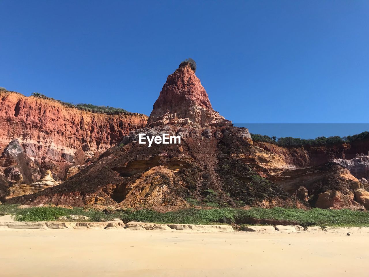 Rock formations against clear blue sky