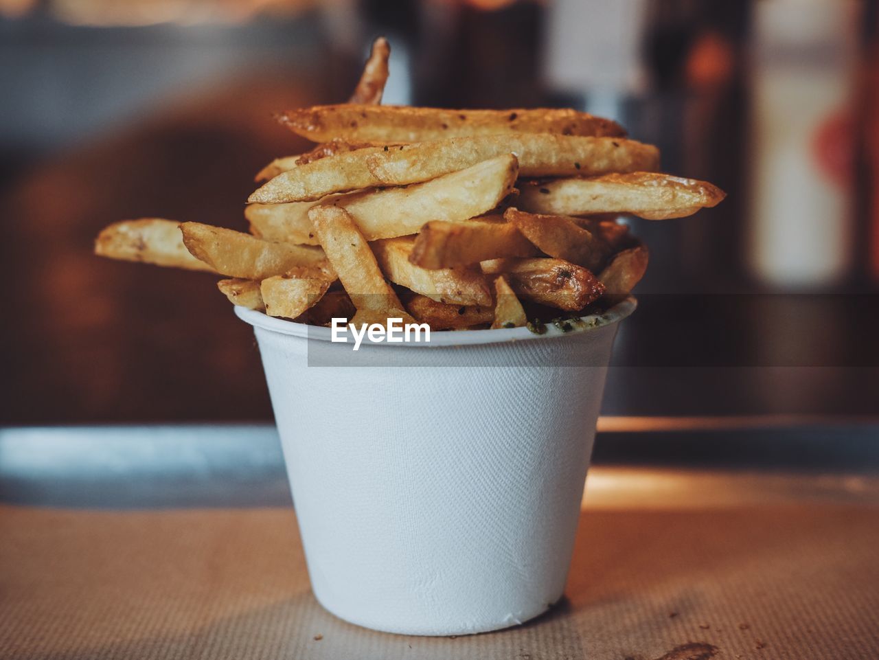 Close-up of french fries in white disposable cup