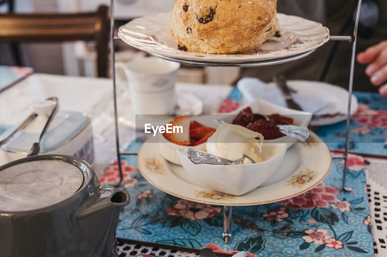 View from above of fruit scones, jam and cream, known as afternoon tea in uk.
