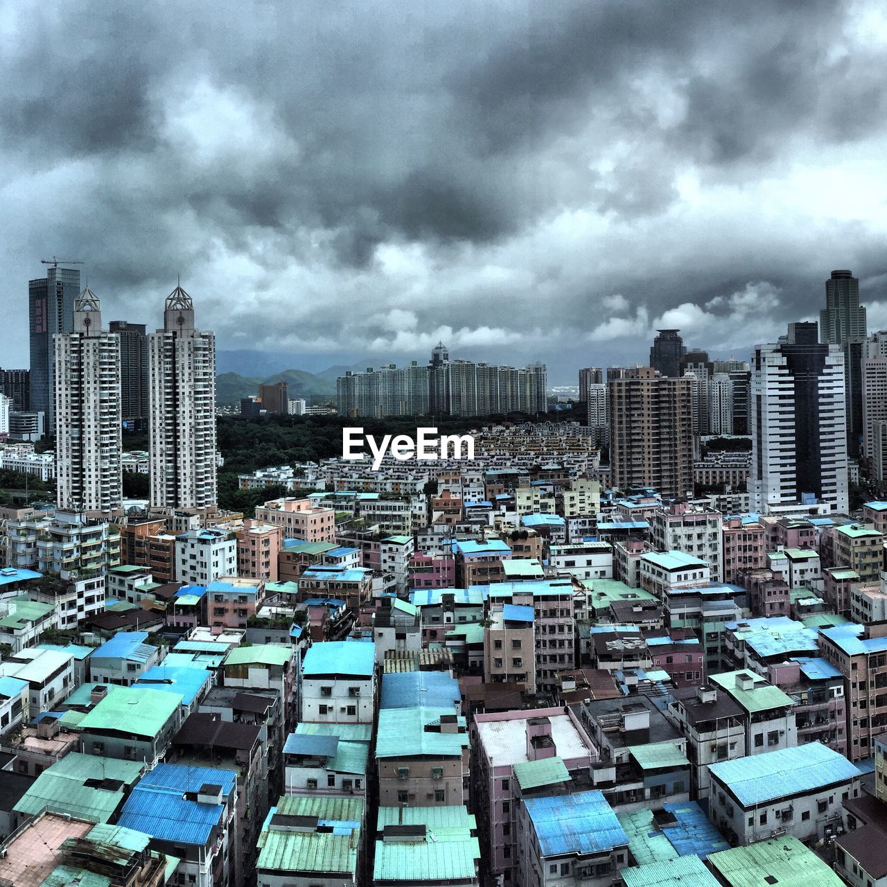 Cityscape against cloudy sky