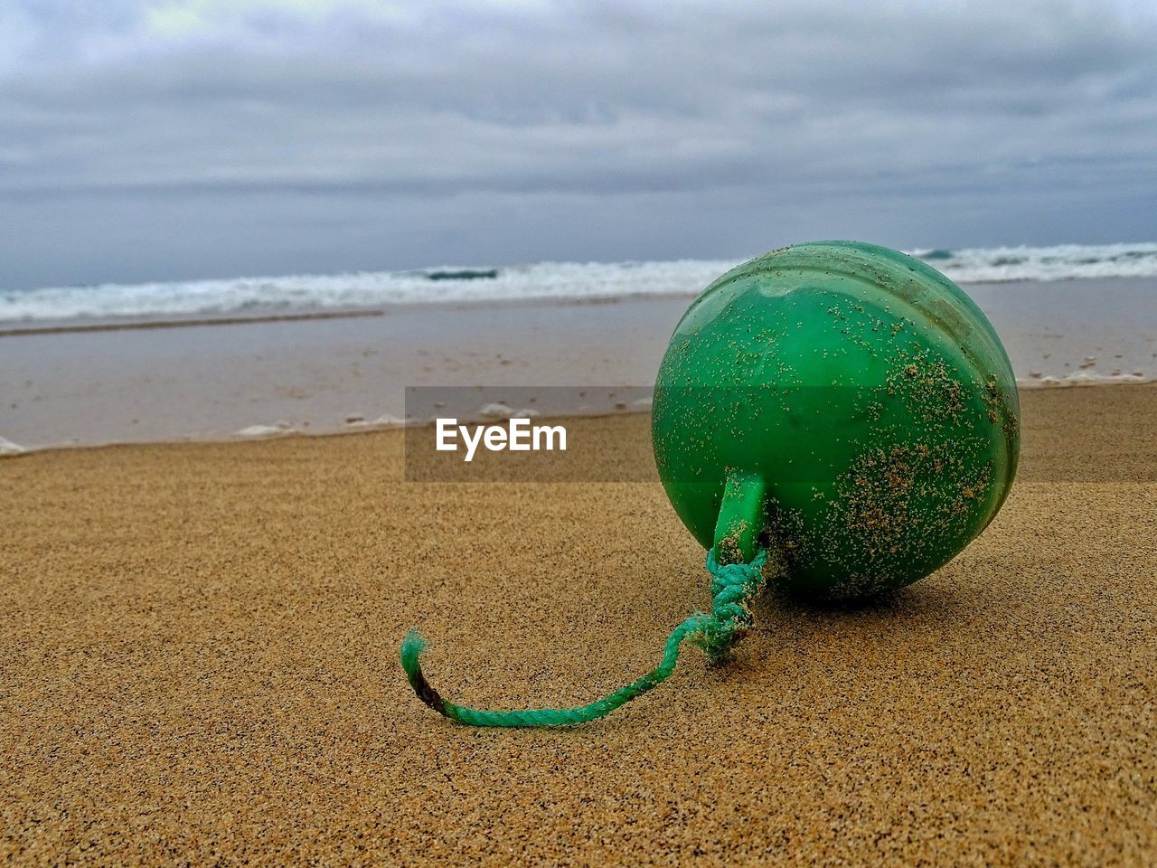 CLOSE-UP OF BLUE BALLS ON BEACH