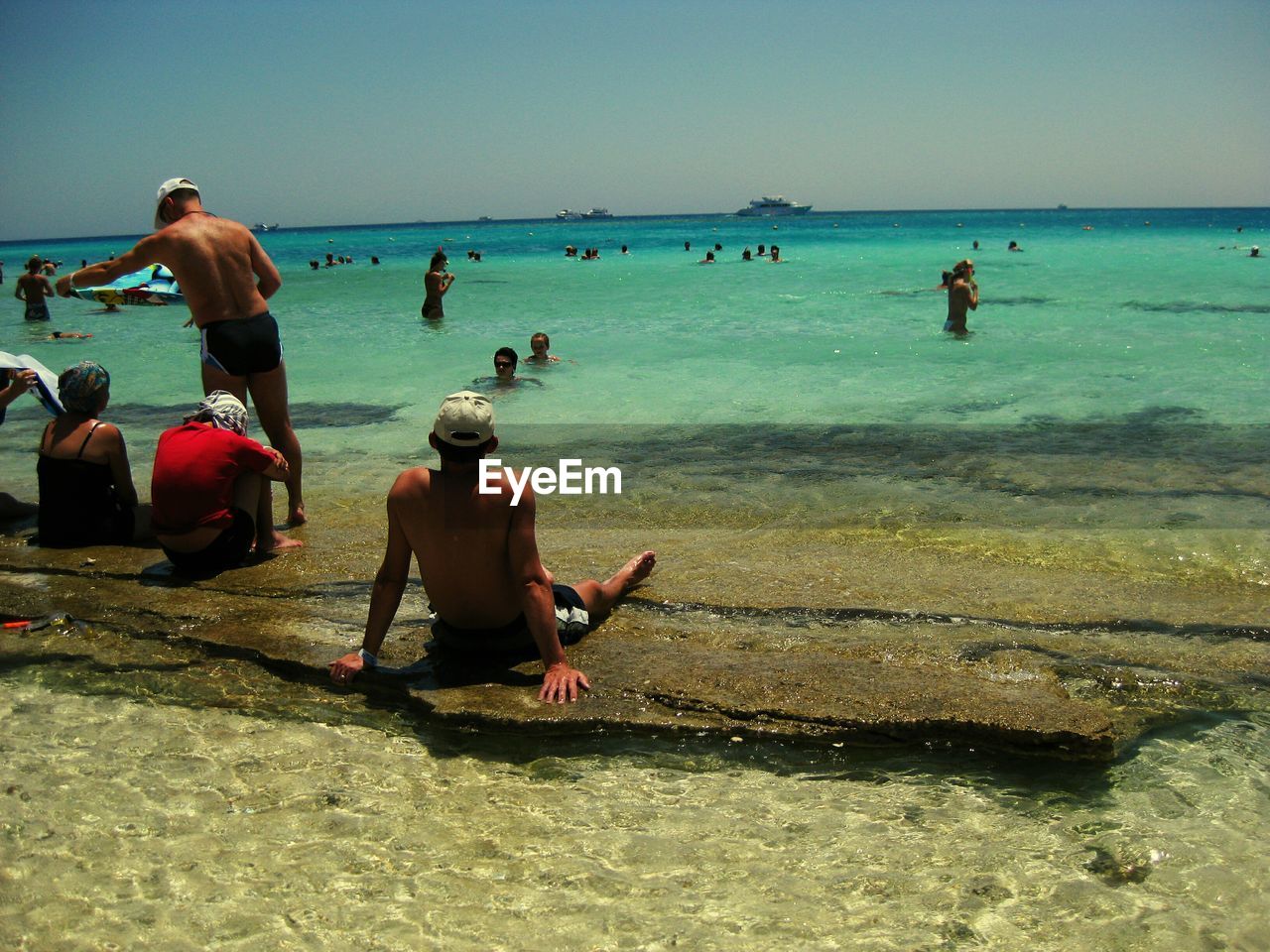 People relaxing at shore