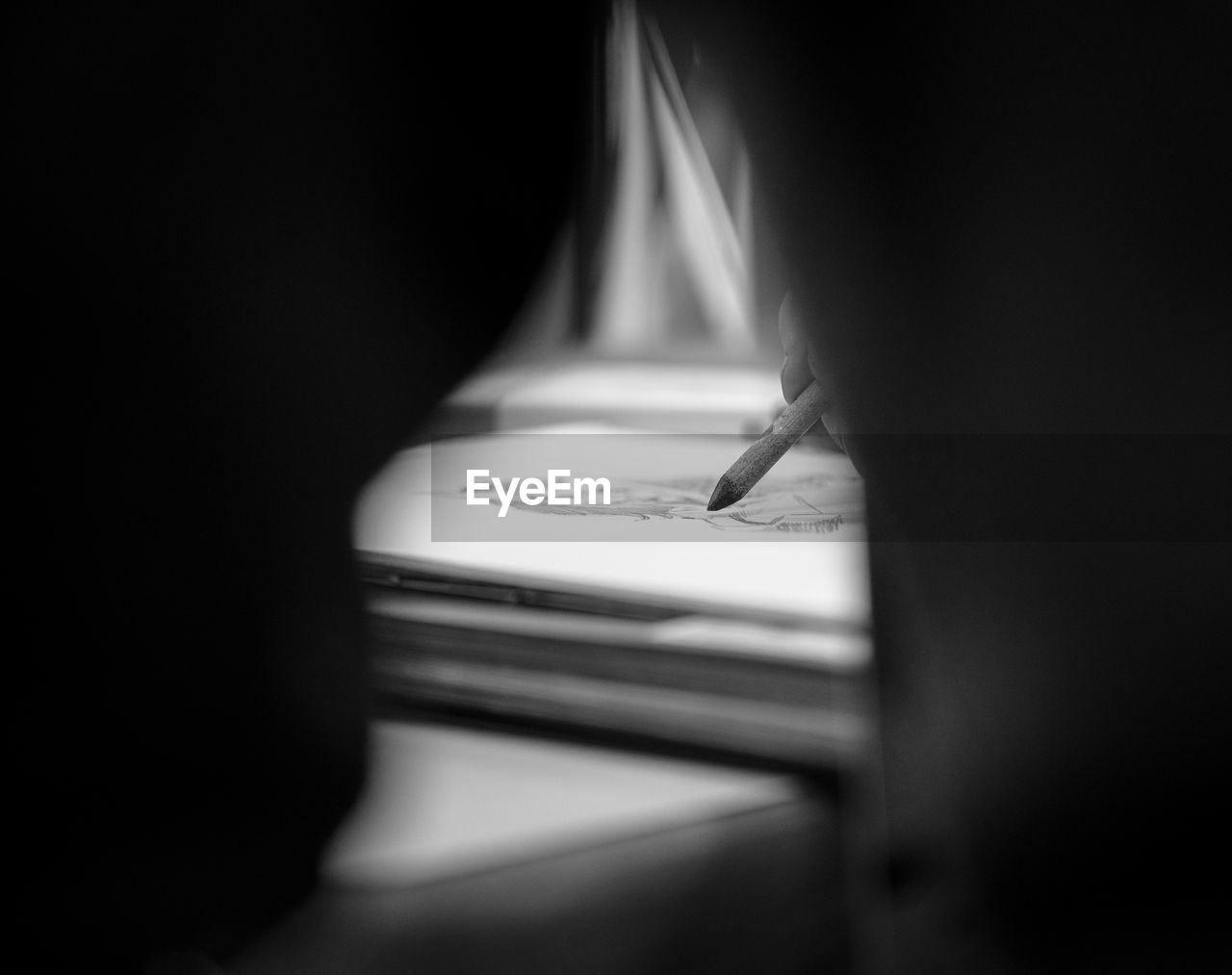 black, white, darkness, light, black and white, indoors, close-up, monochrome photography, monochrome, book, publication, selective focus, communication, one person, black background, dark, paper