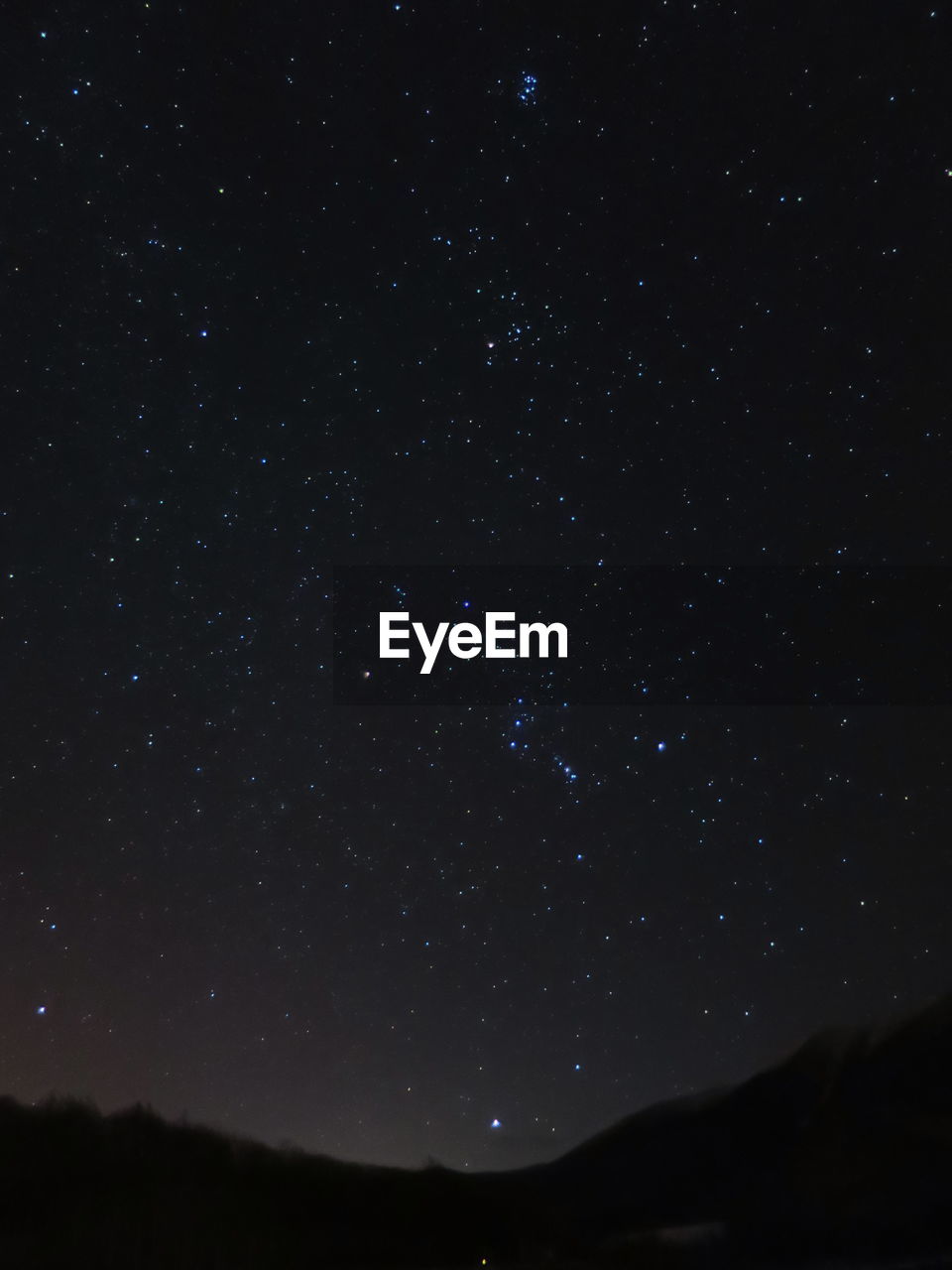 Scenic view of silhouette landscape against star field at night