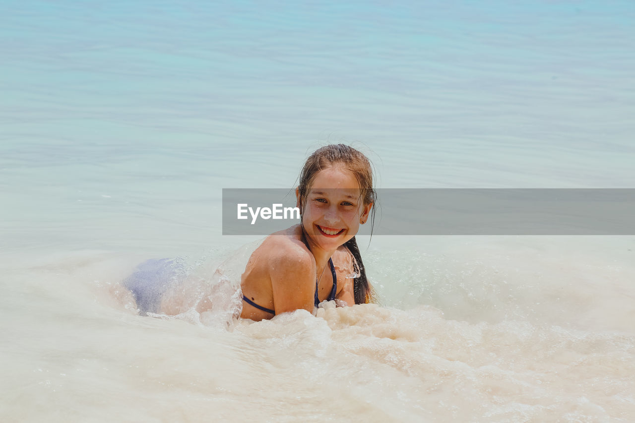 Portrait of smiling girl swimming in sea