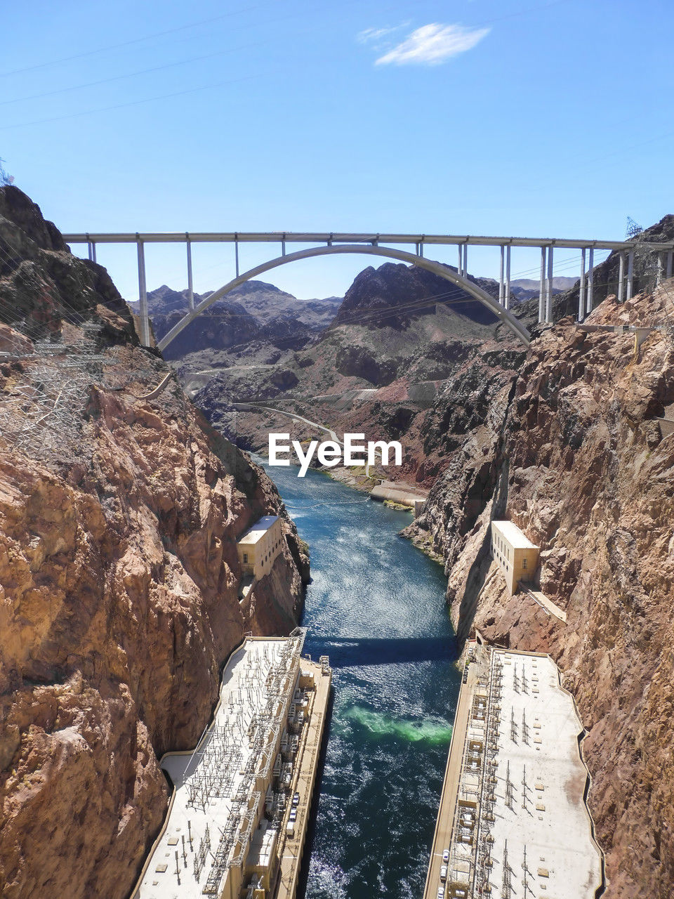 water, bridge, nature, built structure, architecture, dam, sky, hydroelectric power, travel destinations, power generation, scenics - nature, infrastructure, rock, environment, day, no people, transportation, river, travel, coast, beauty in nature, outdoors, tourism, environmental conservation, mountain, sunlight, renewable energy, reservoir, non-urban scene, canyon, landscape, high angle view, rock formation