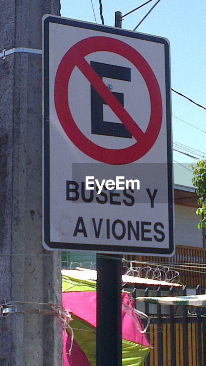 CLOSE-UP OF ROAD SIGN AGAINST THE SKY