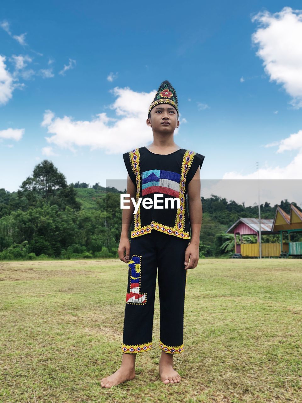 Full length portrait of muruts boy standing on field, sepulut nabawan sabah