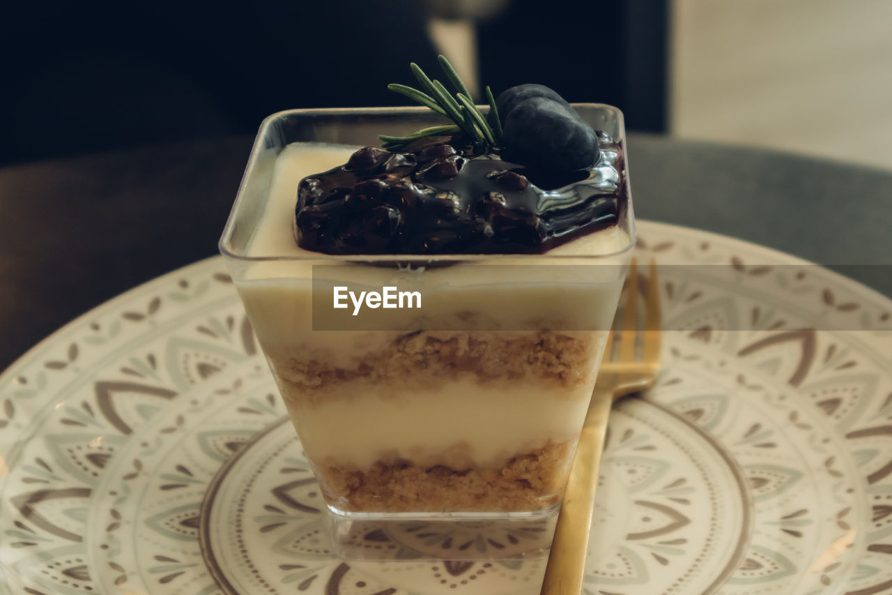 CLOSE-UP OF ICE CREAM IN PLATE ON TABLE