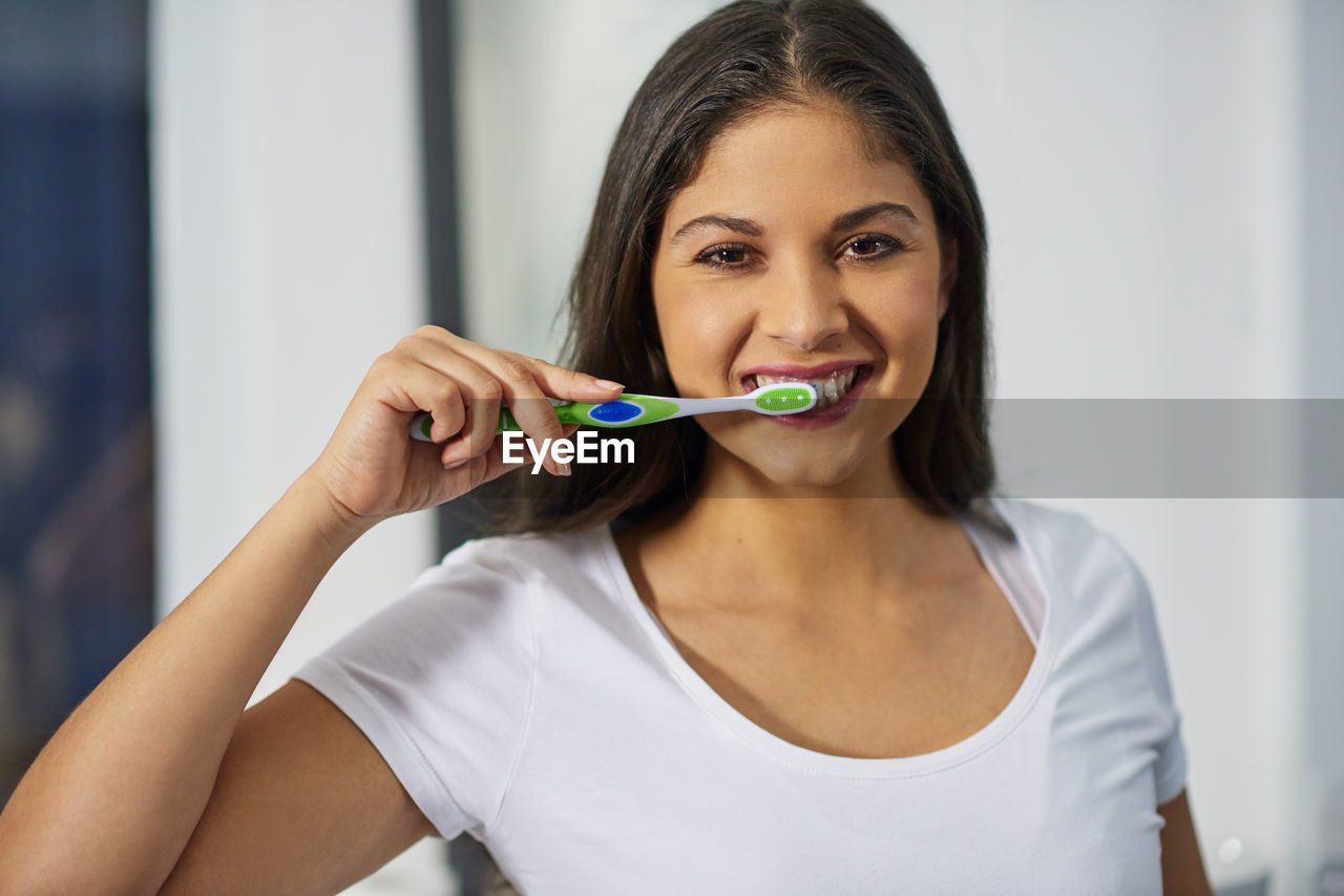 oral hygiene, toothbrush, women, one person, adult, portrait, indoors, happiness, person, young adult, smiling, wellbeing, holding, skin, lifestyles, human mouth, front view, domestic life, looking at camera, female, brush, dental health, teenager, hand, brown hair, food, routine, emotion, cheerful, human face, eating, healthcare and medicine, body care, domestic room, lip, food and drink, hygiene, hairstyle, personal care, headshot, enjoyment, photo shoot, casual clothing, healthy eating, human hair, close-up, focus on foreground, long hair, spoon, nose, home interior