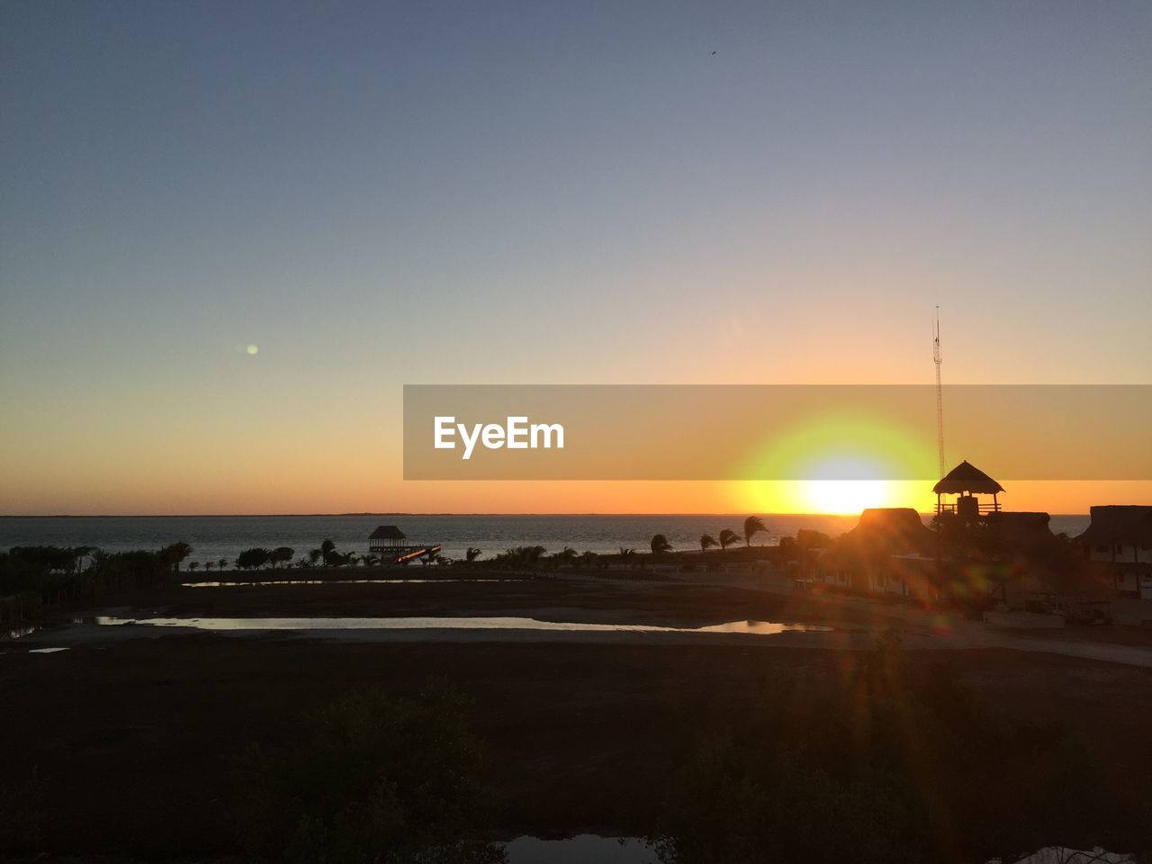 SCENIC VIEW OF SUNSET OVER SEA