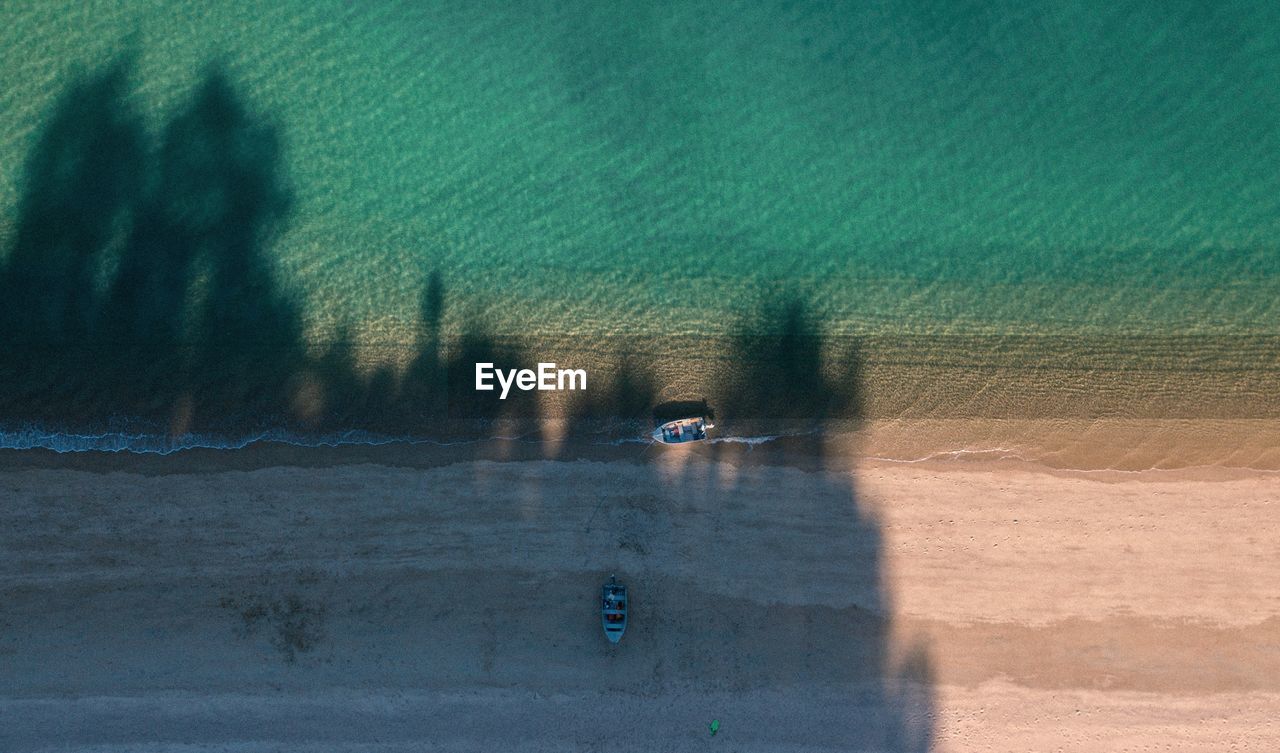 High angle view of boats moored on beach by sea