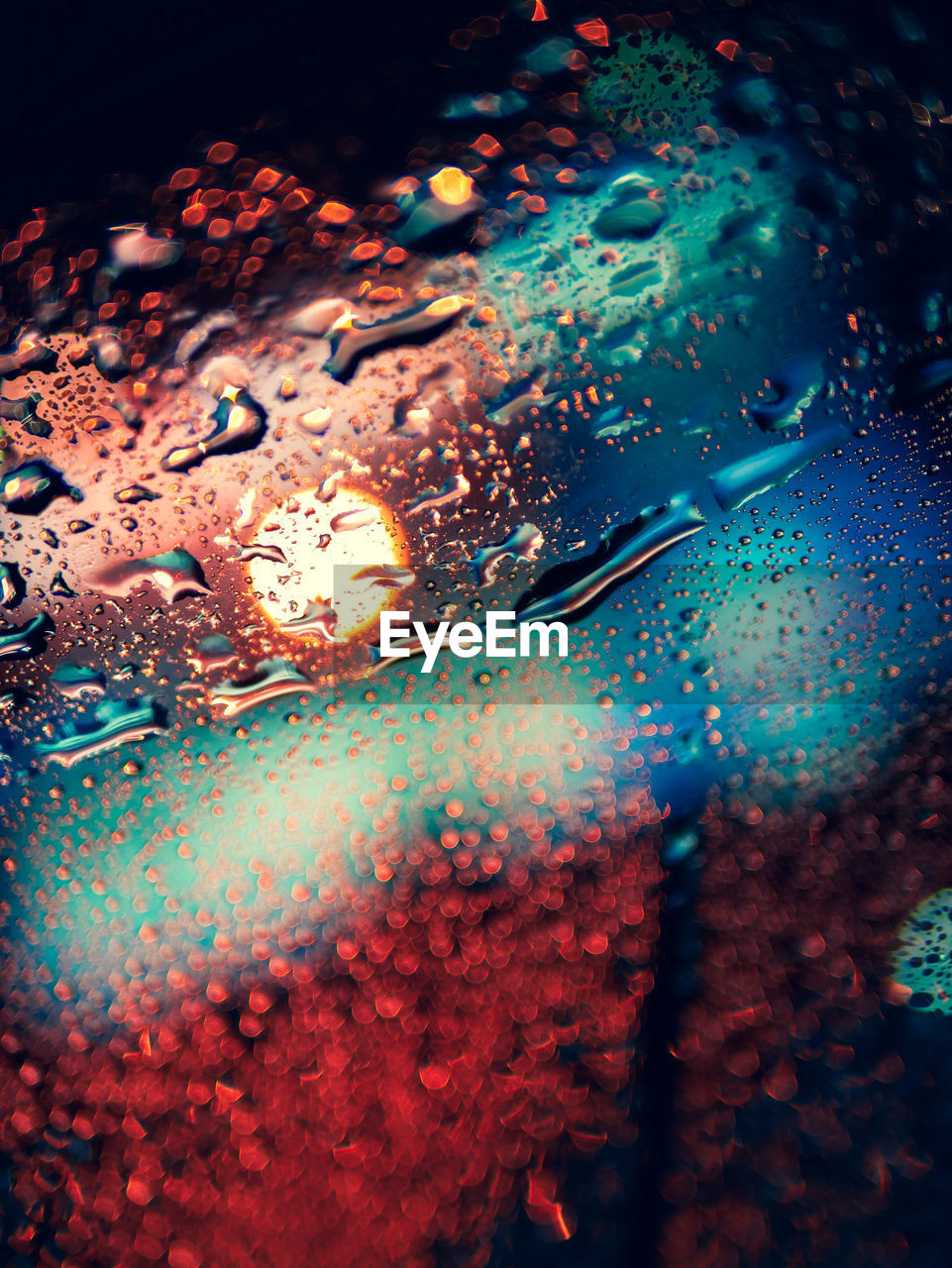 Close-up of raindrops on car windshield