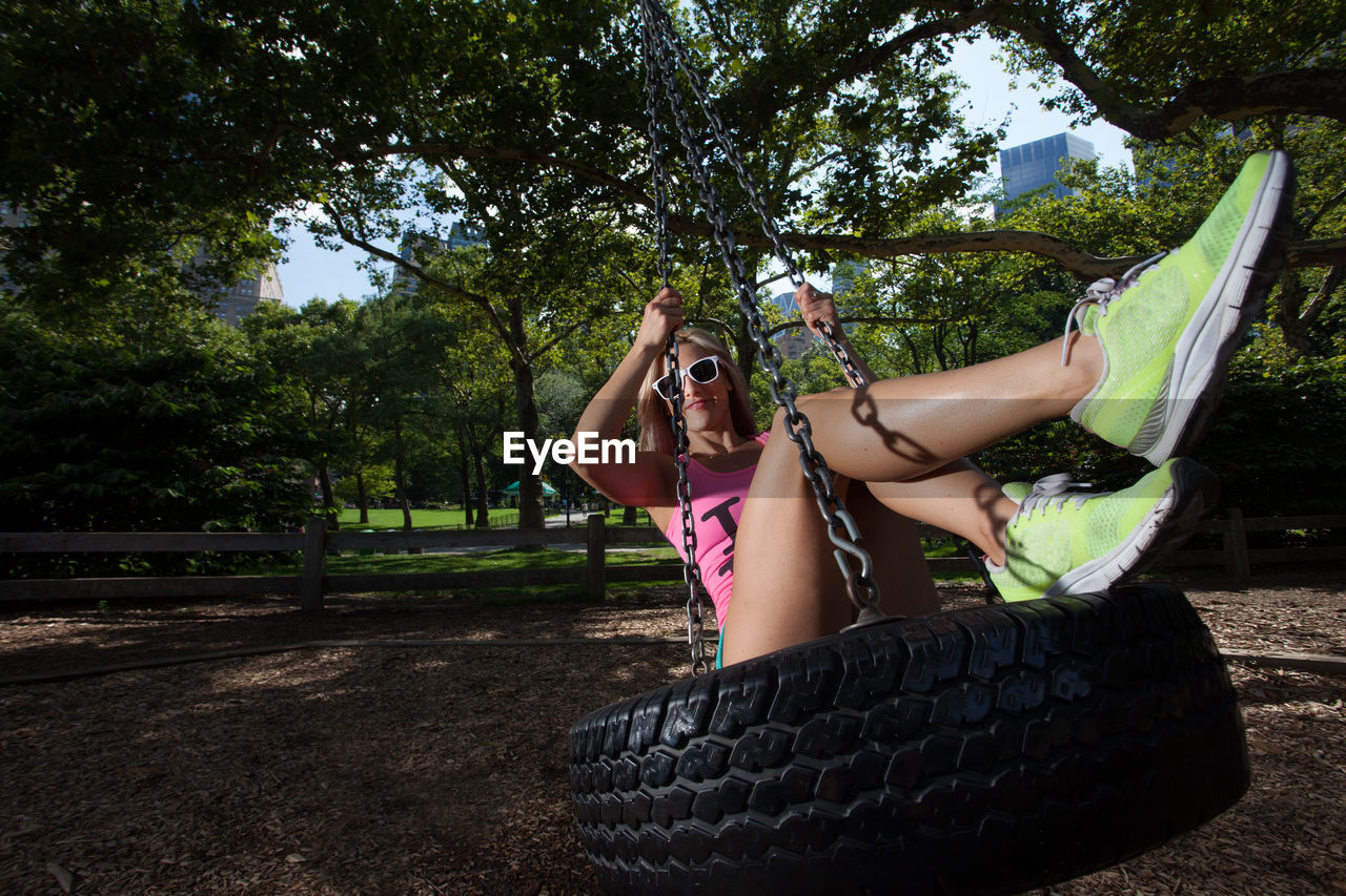 Full length of woman on swing at park