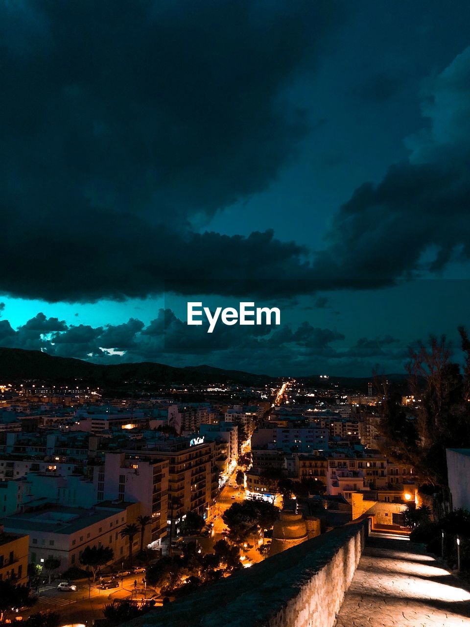 Aerial view of illuminated city against sky at night