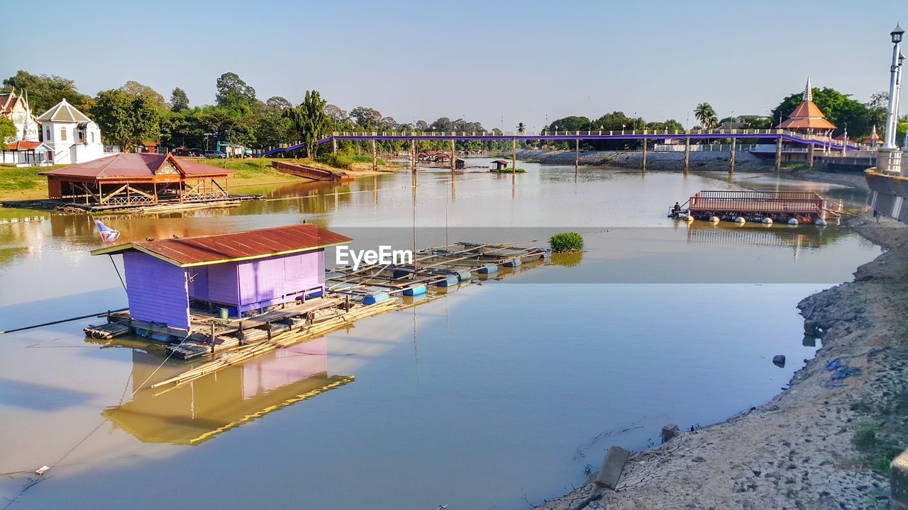 VIEW OF SWIMMING POOL BY RIVER AGAINST SKY