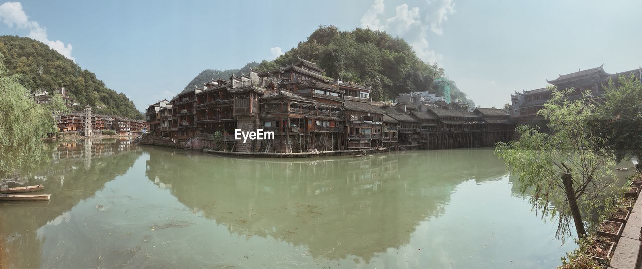 Panoramic view of lake and buildings against sky