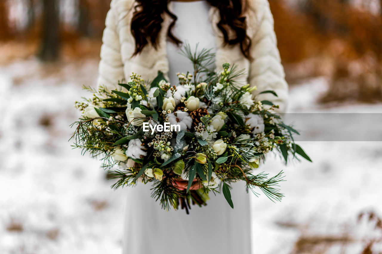 Close-up of woman holding flower bouquet