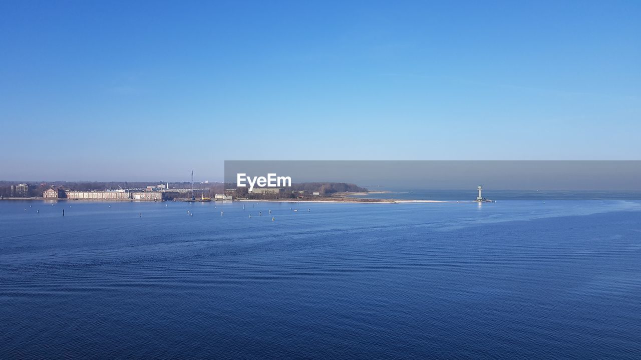 Scenic view of sea against clear blue sky