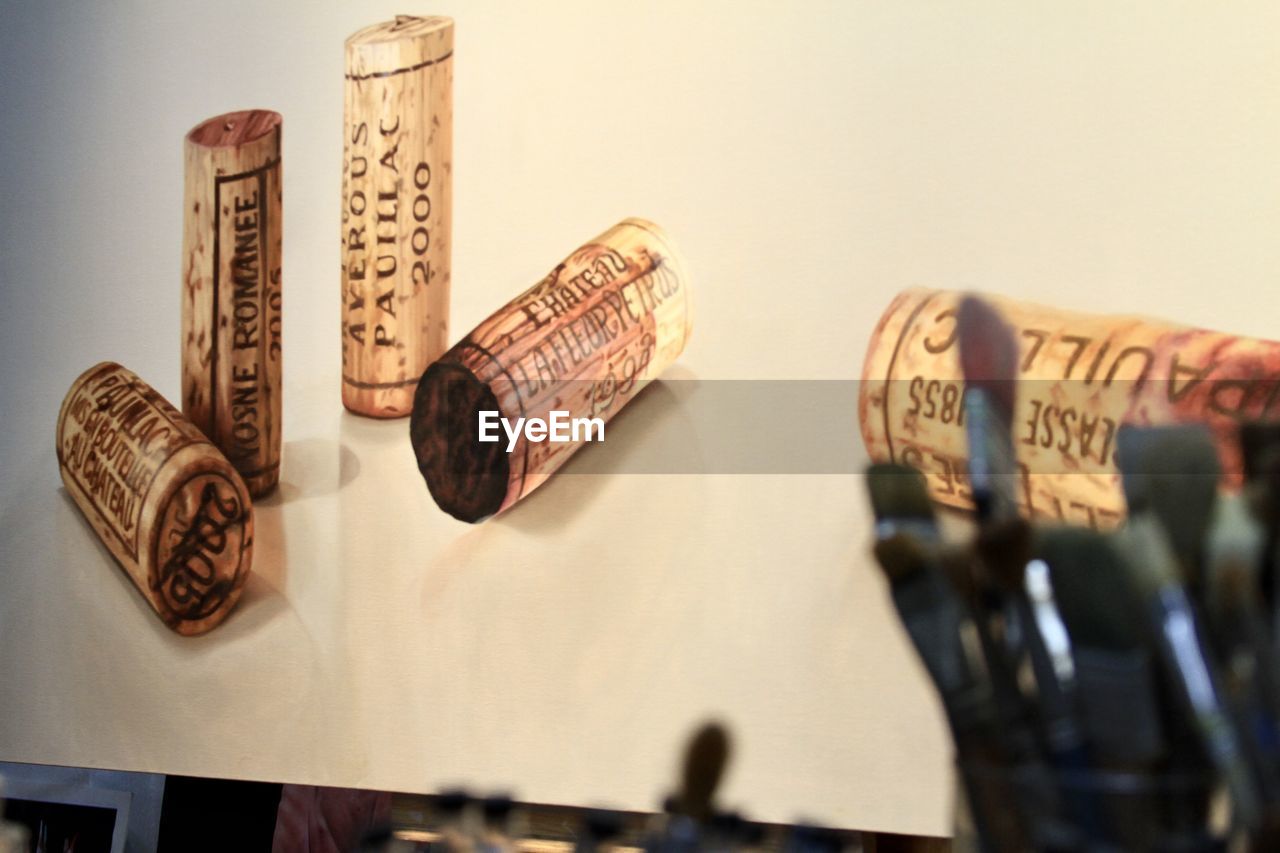 CLOSE-UP OF WINE BOTTLES ON WOODEN TABLE