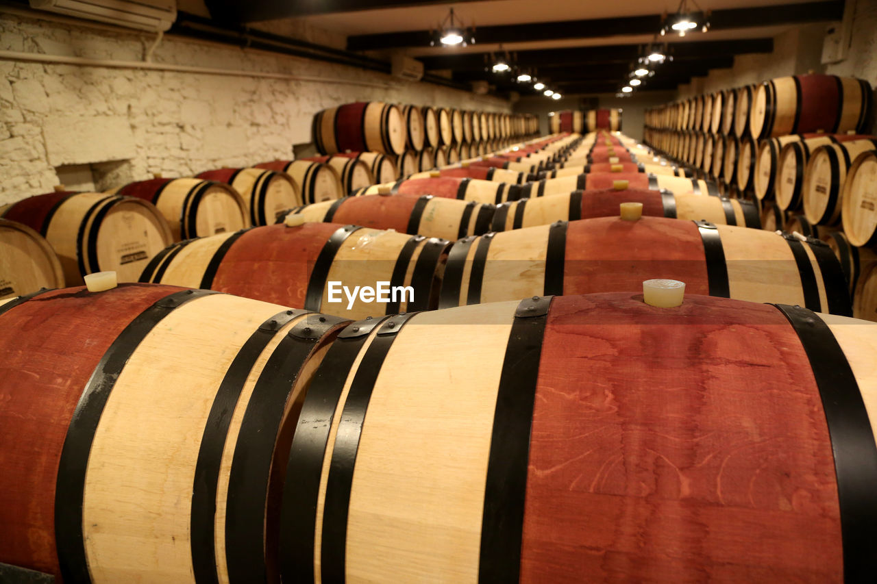 Row of wine barrels in building