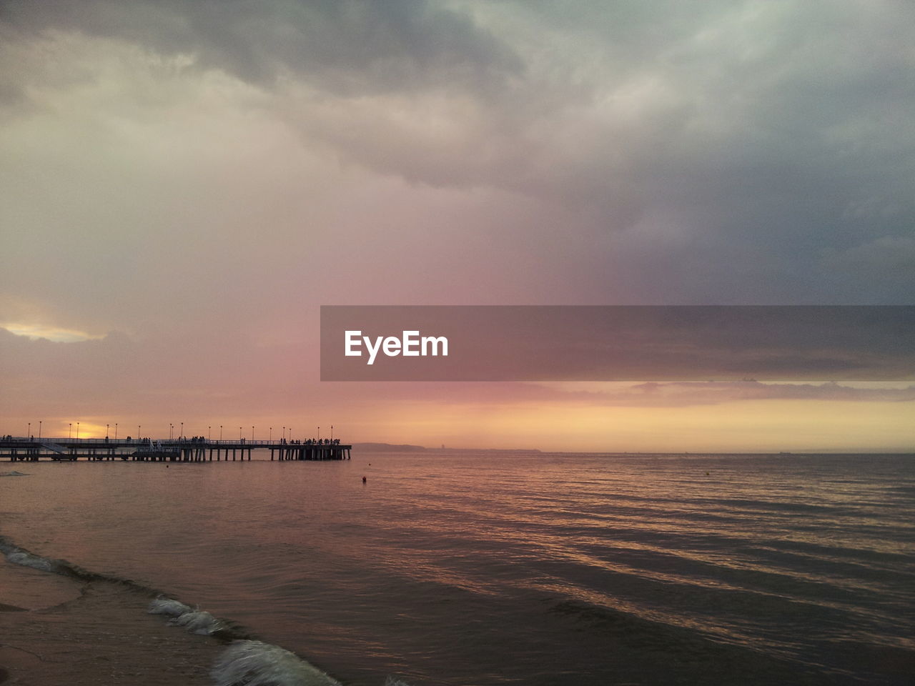 Scenic view of sea against cloudy sky