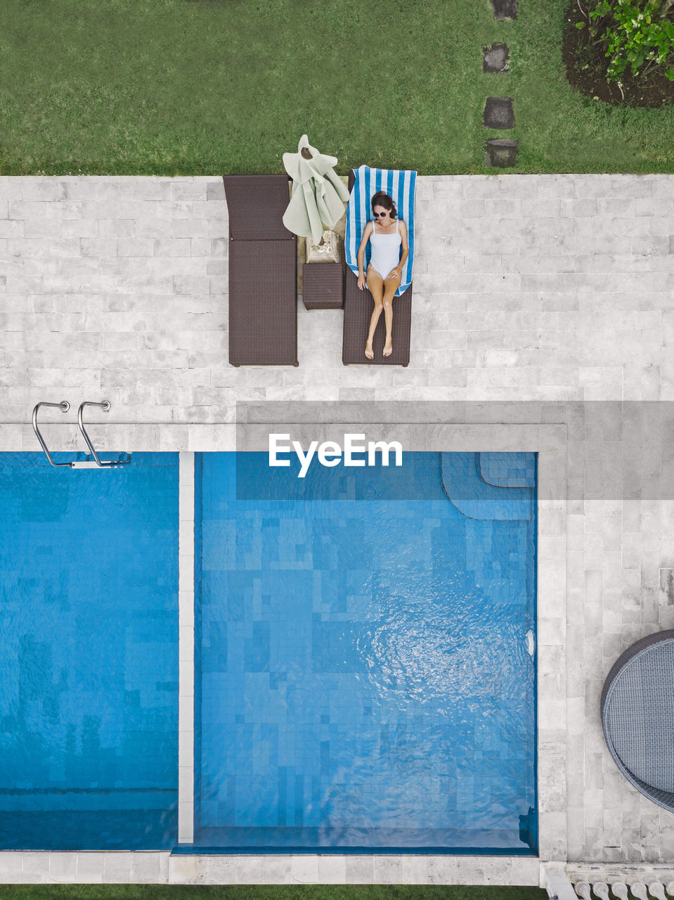 Aerial view of attractive woman near the pool at resort