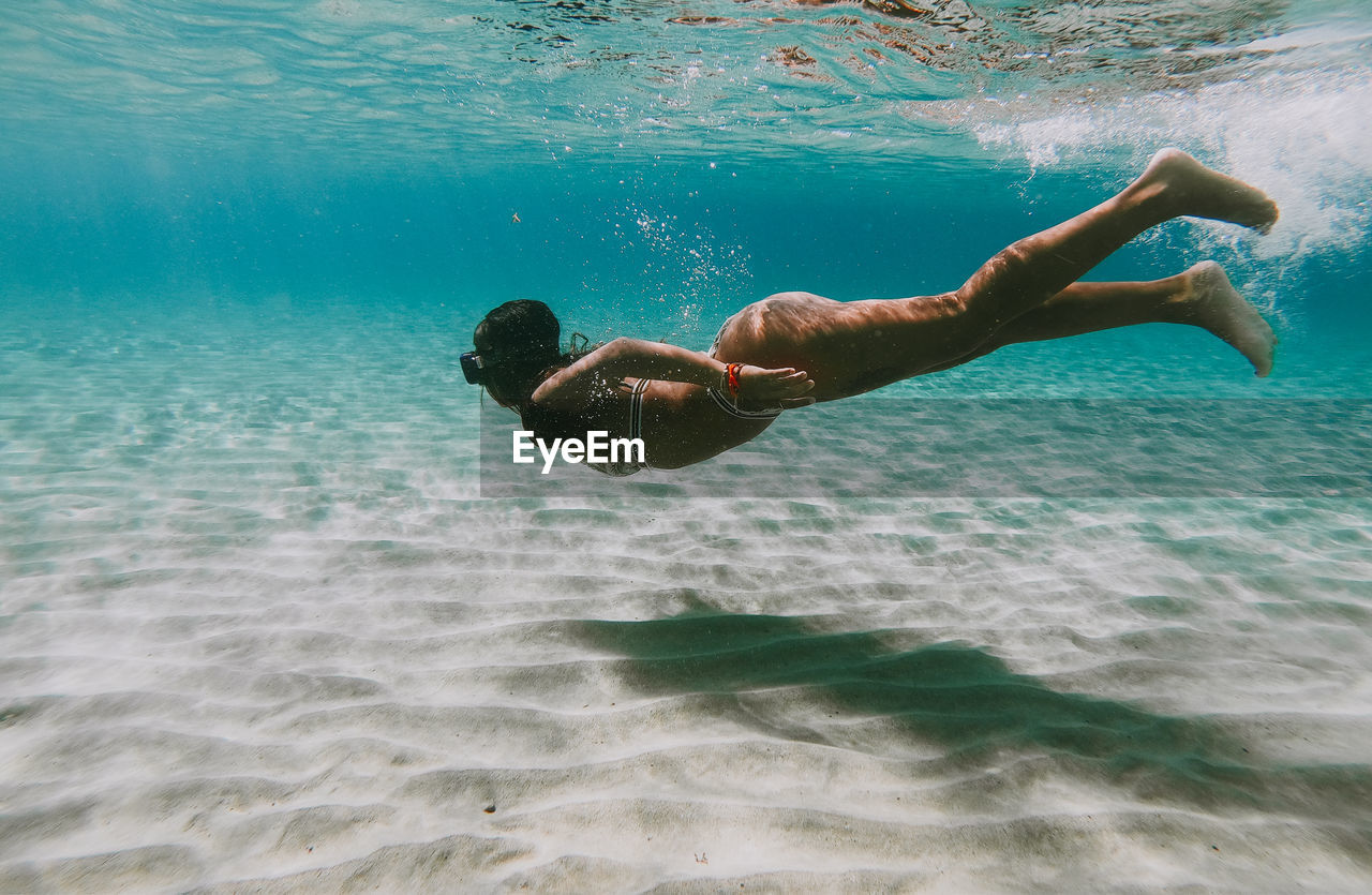 Woman swimming undersea