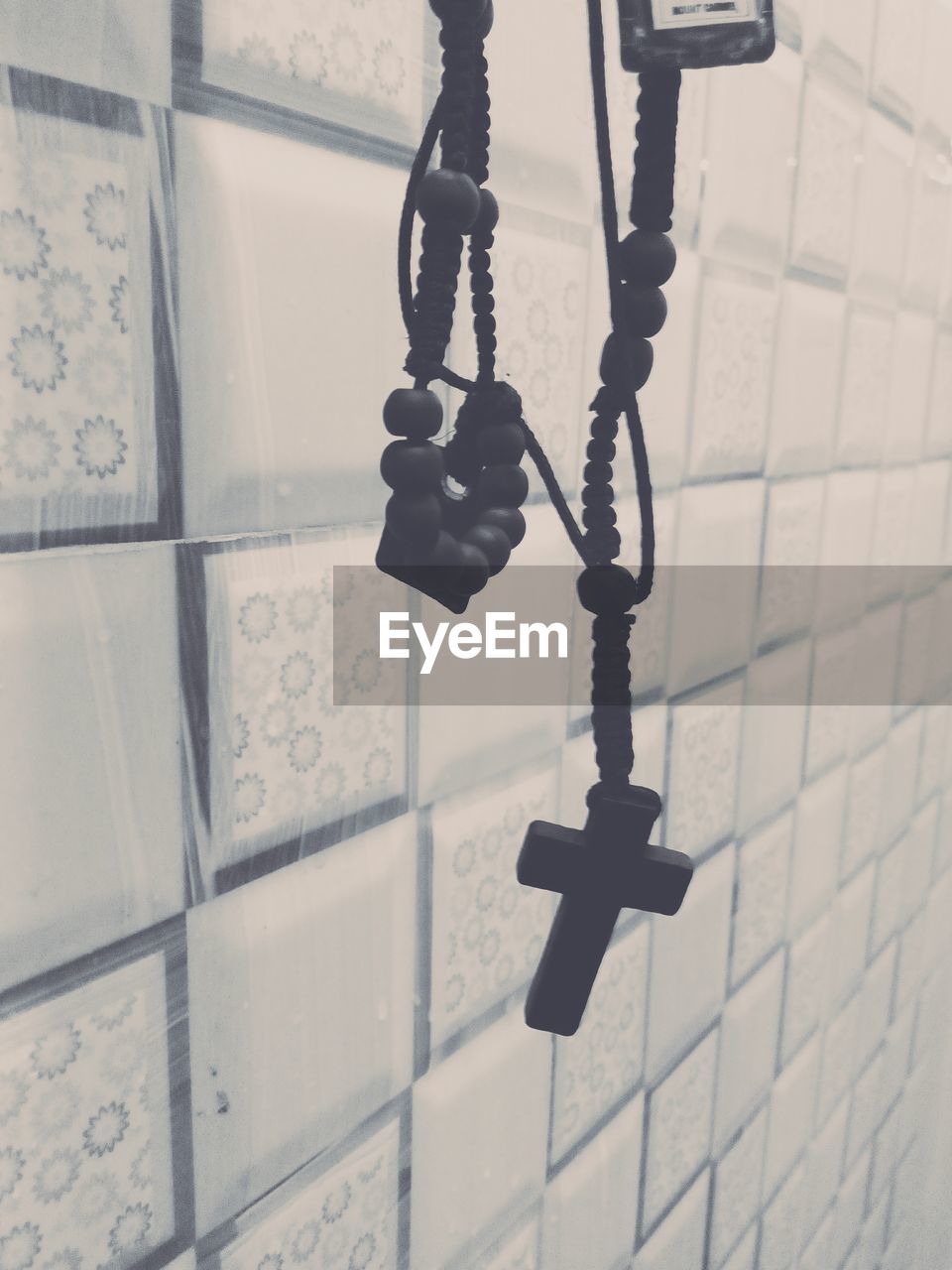 LOW ANGLE VIEW OF CHAIN HANGING ON WALL