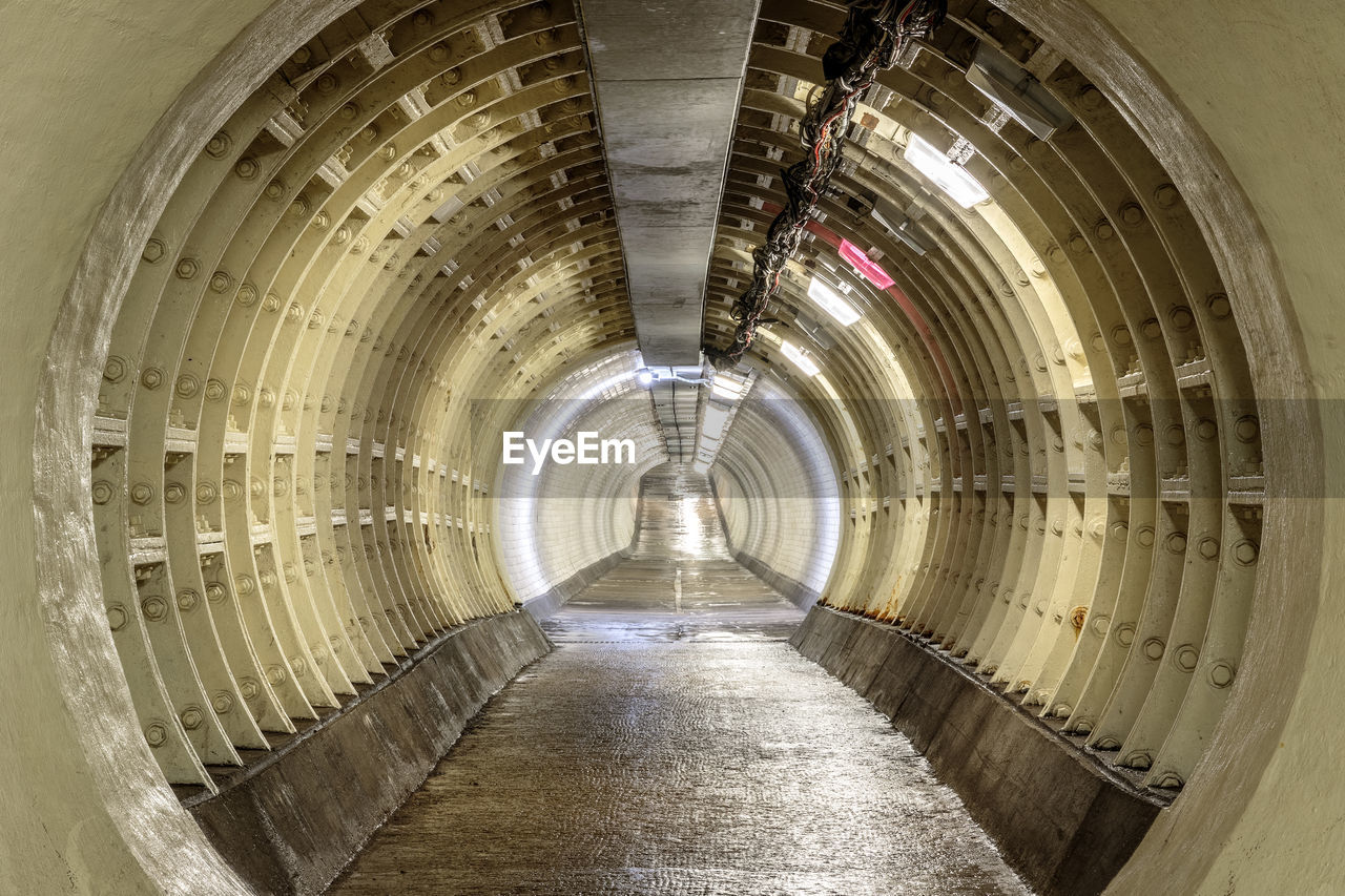 VIEW OF EMPTY TUNNEL WITH BUILDING IN SUBWAY