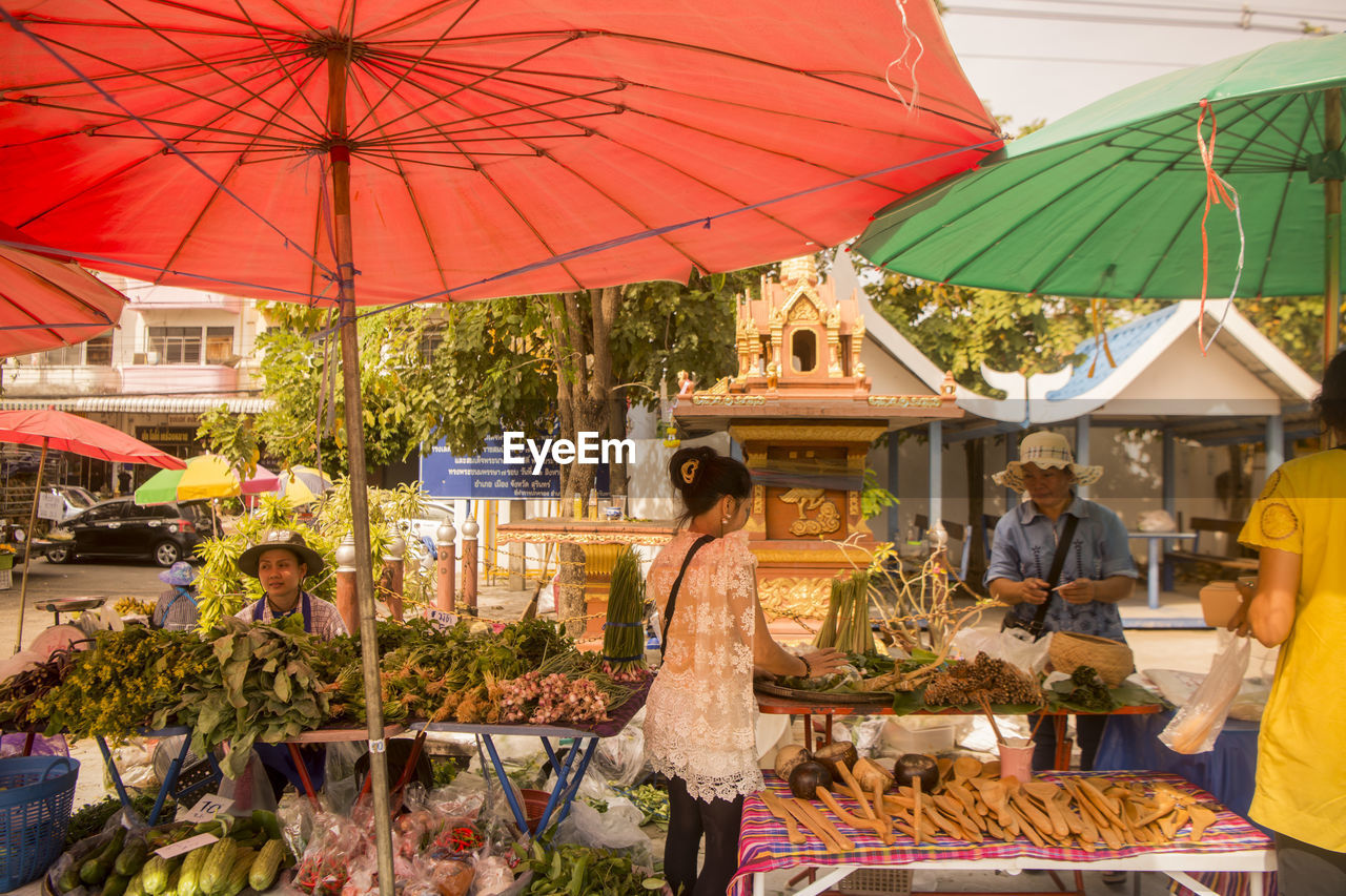 GROUP OF PEOPLE IN MARKET STALL