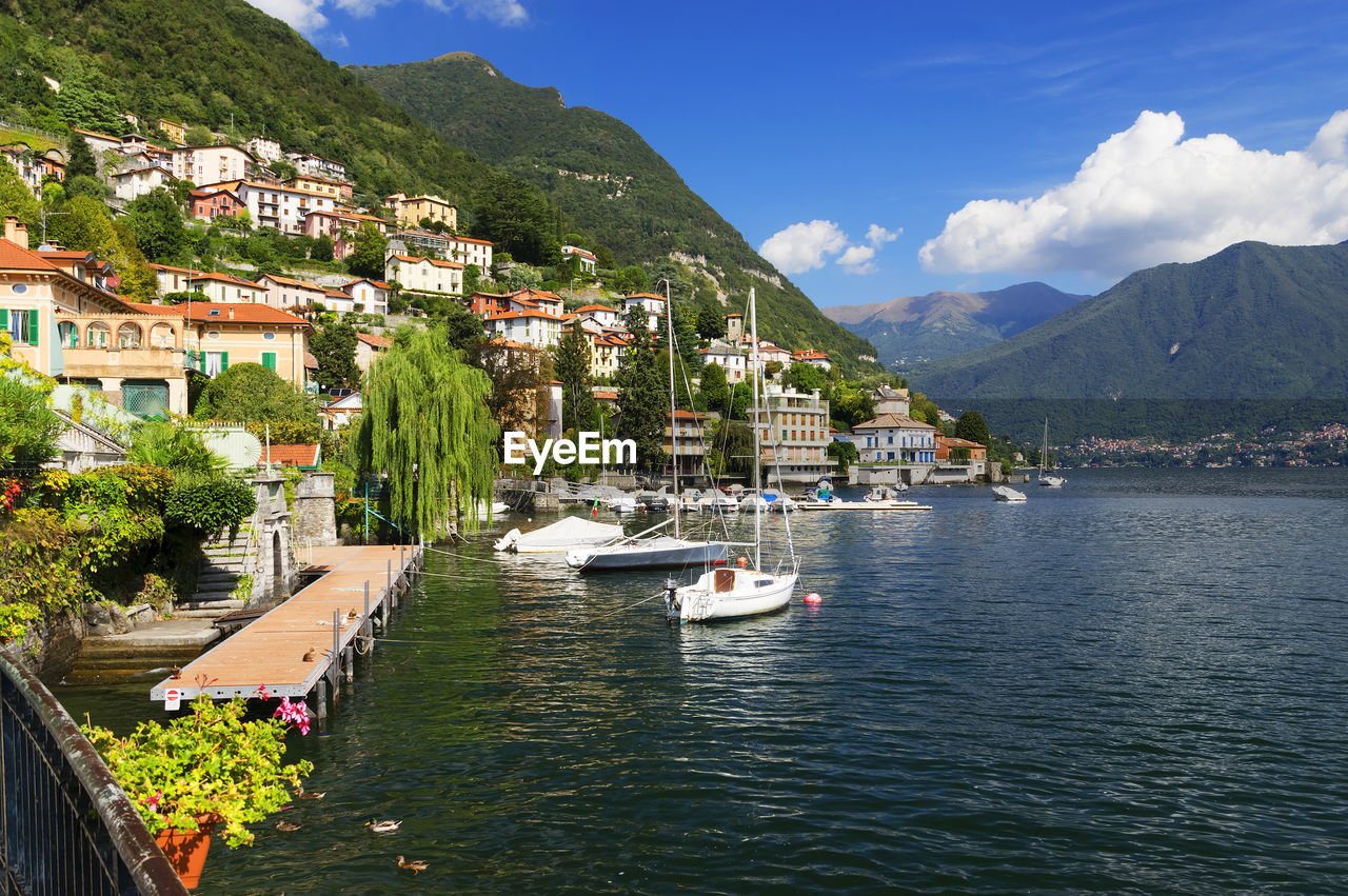 Boats in river against built structures