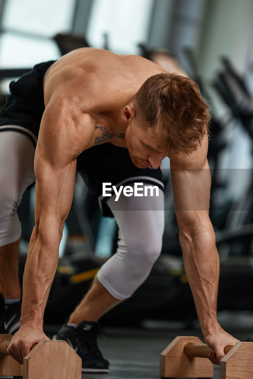 rear view of man exercising in gym