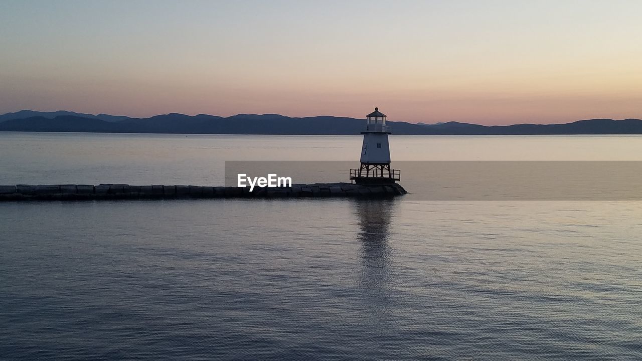 BOAT IN SEA AGAINST SKY DURING SUNSET