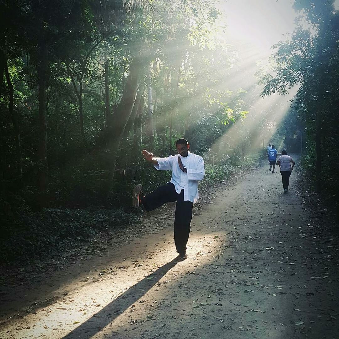 REAR VIEW OF WOMAN RUNNING ON LANDSCAPE