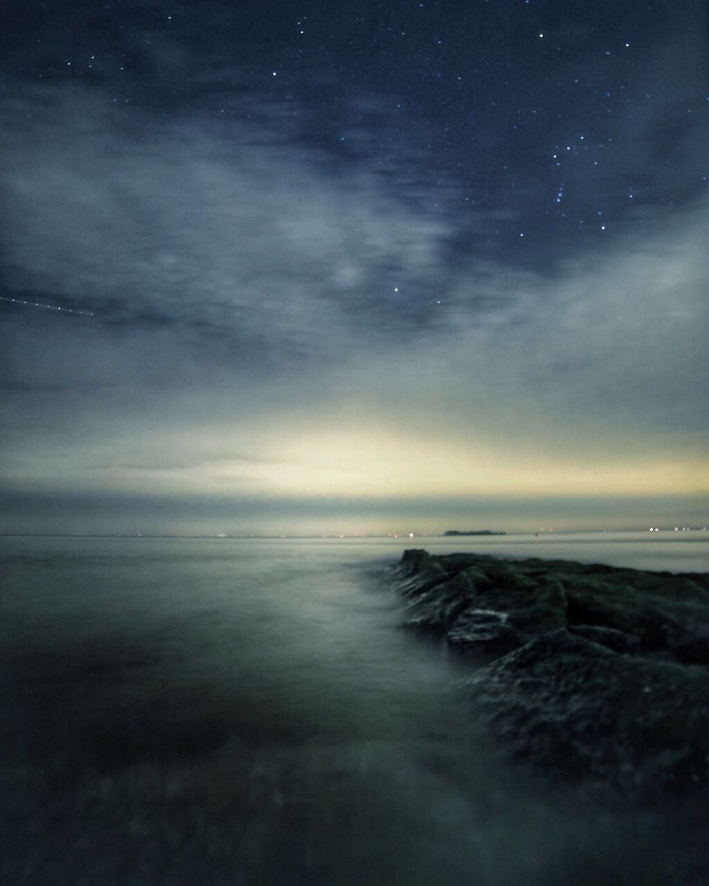 Scenic shot of calm sea against cloudy sky