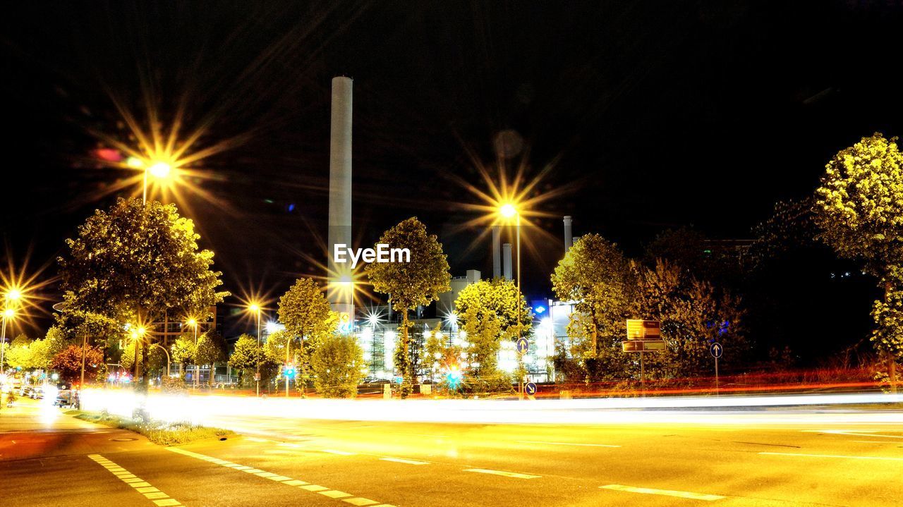 LIGHT TRAILS ON ROAD AT NIGHT