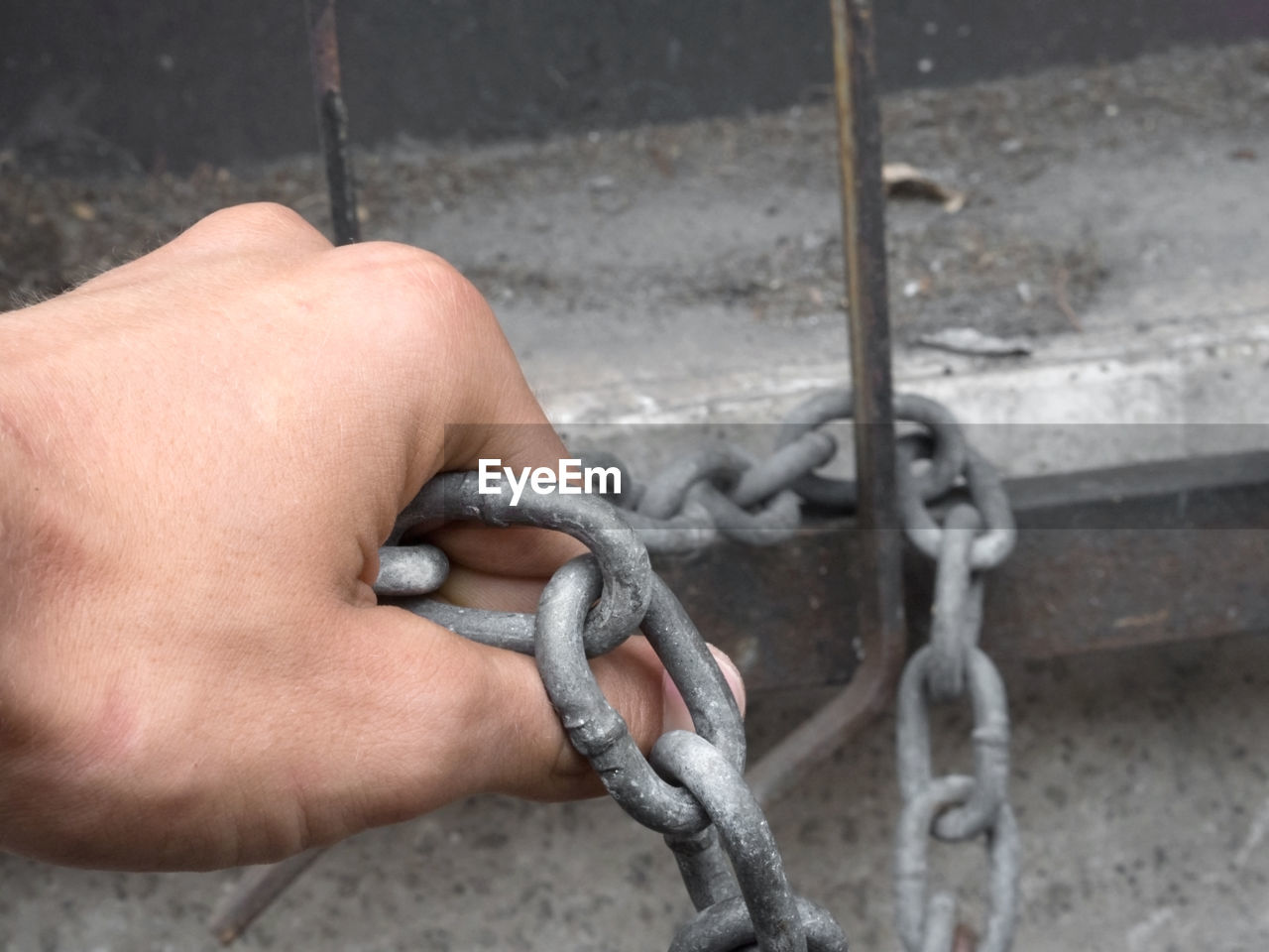 Cropped hand holding chain