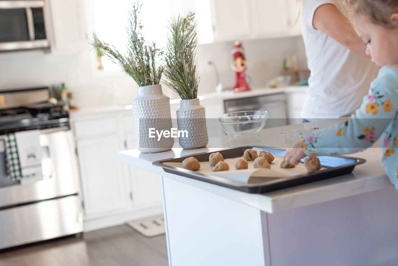 Midsection of woman having food at home